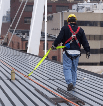 Image of a person on a roof using fall protection